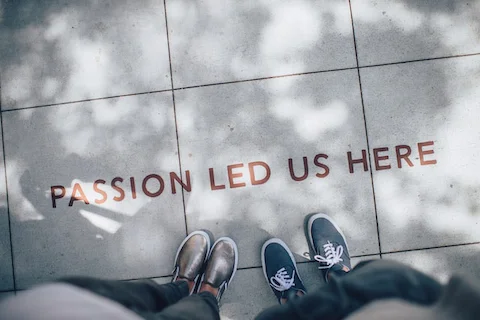 two people standing on tile floor that says 'Passion led us here'
